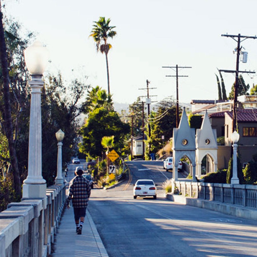 Man walking away across historic bridge in Los Feliz