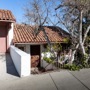 Front entrance area of a single family home with red terra cotta roof